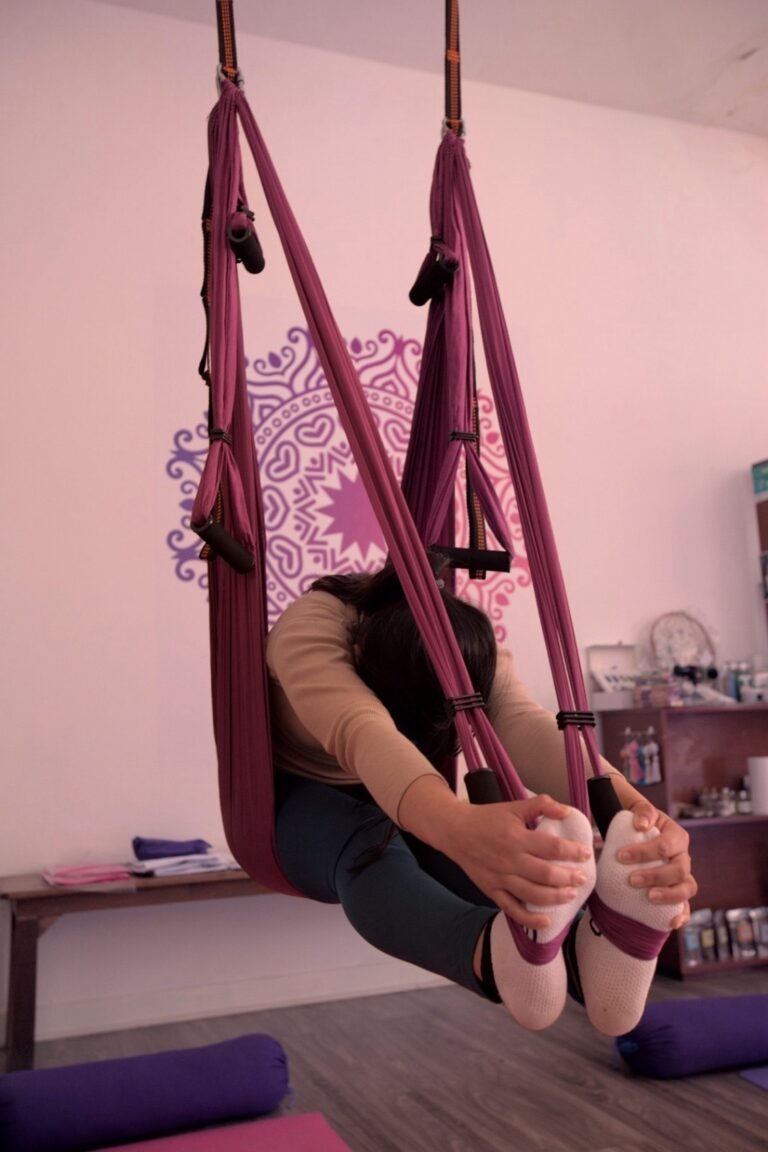Women practicing aerial yoga with YogaAereo in Browns Bay, North Shore Auckland.